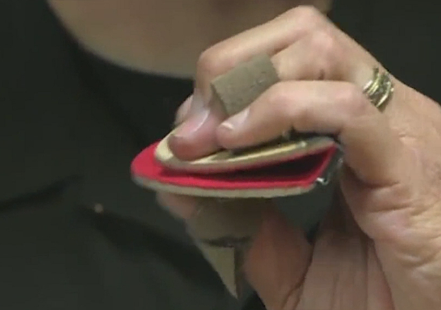 Hand demonstrating how the mouthplate can simulate an underbite